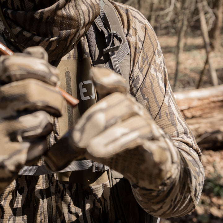 Adapt Long Sleeve tight shot of zipper pocket in turkey woods#color_original-bottomland