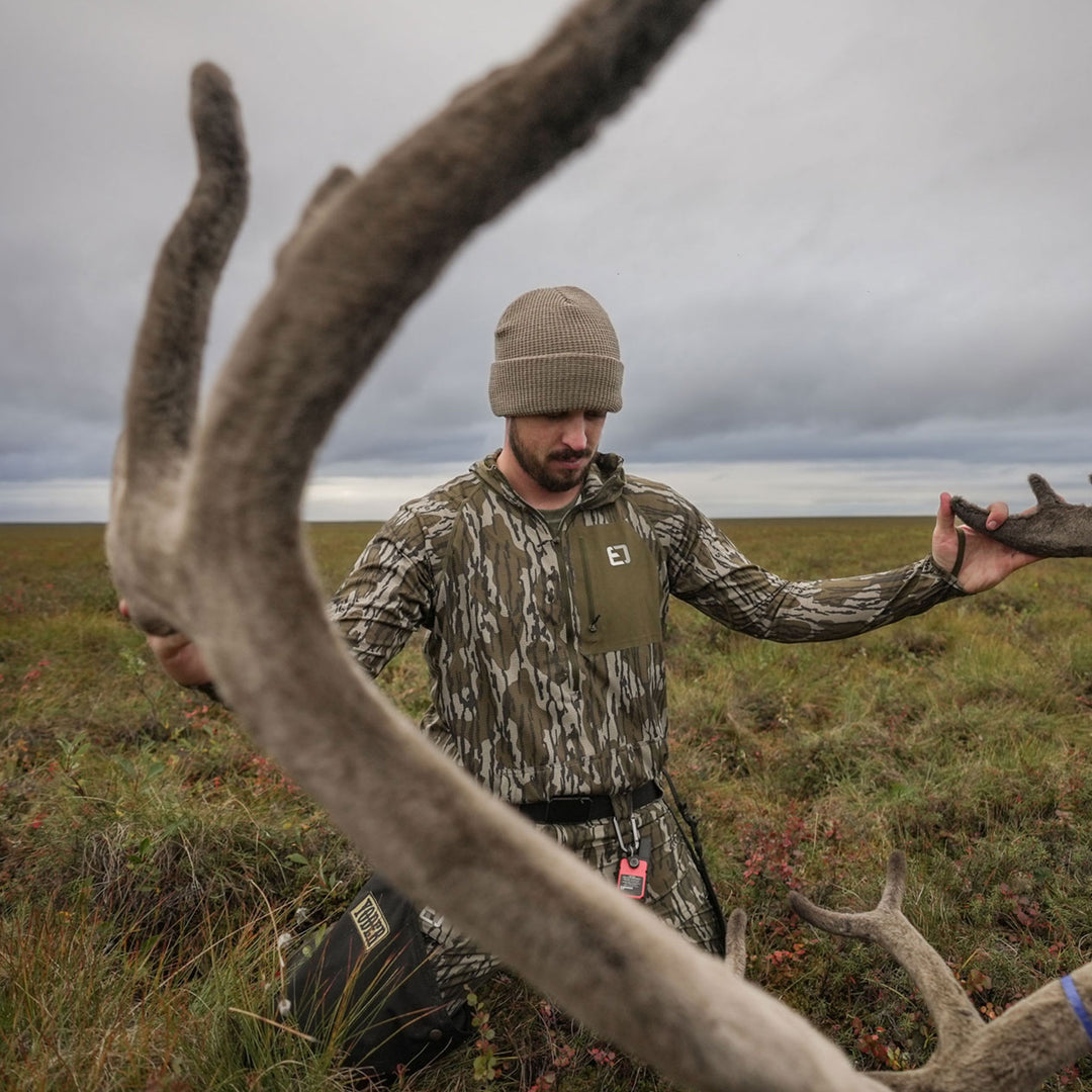 man admiring antlers in adapt hoodie #color_original-bottomland