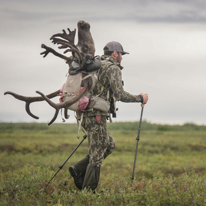 man packing out caribou #color_original-bottomland