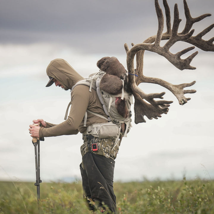 Man packing out caribou in adapt hoodie#color_Coyote