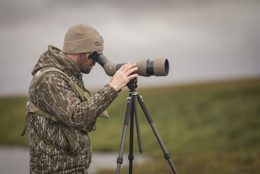 Man looking through spotting scope #color_Original-bottomland