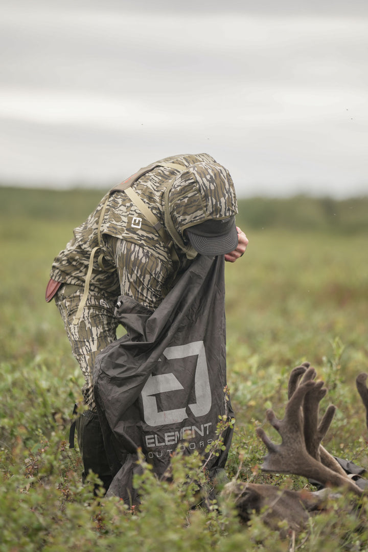 man reaching into meat bag #color_original_bottomland