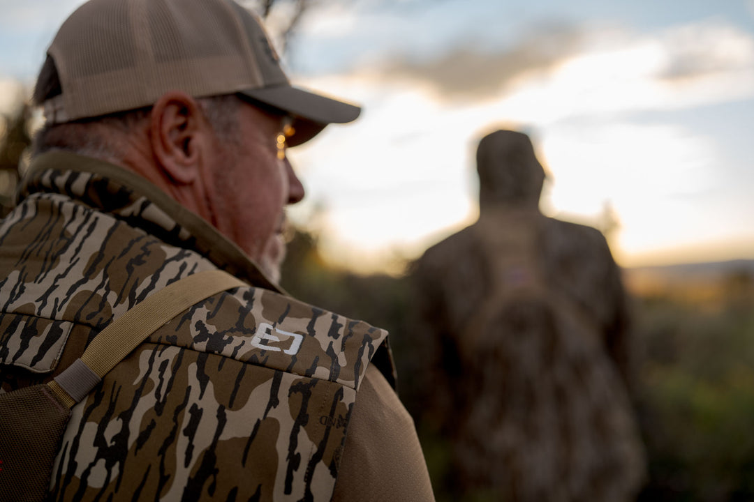 man walking through wilderness #color_original-bottomland