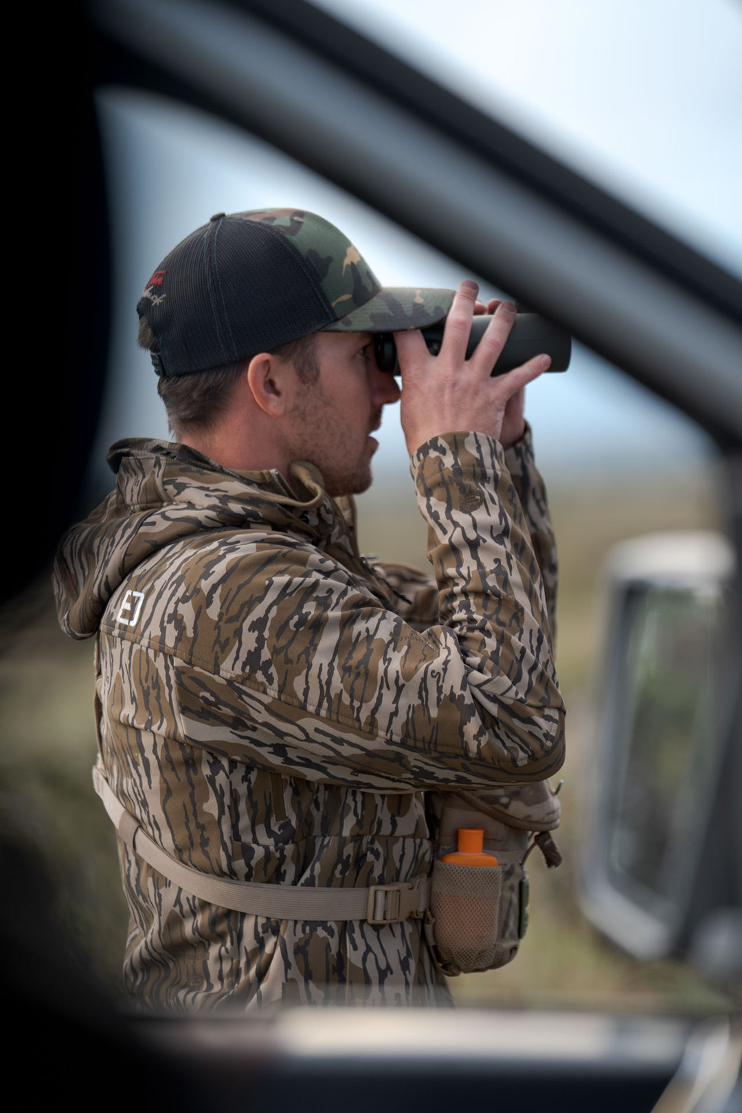 Man looking through binoculars #color_original-bottomland