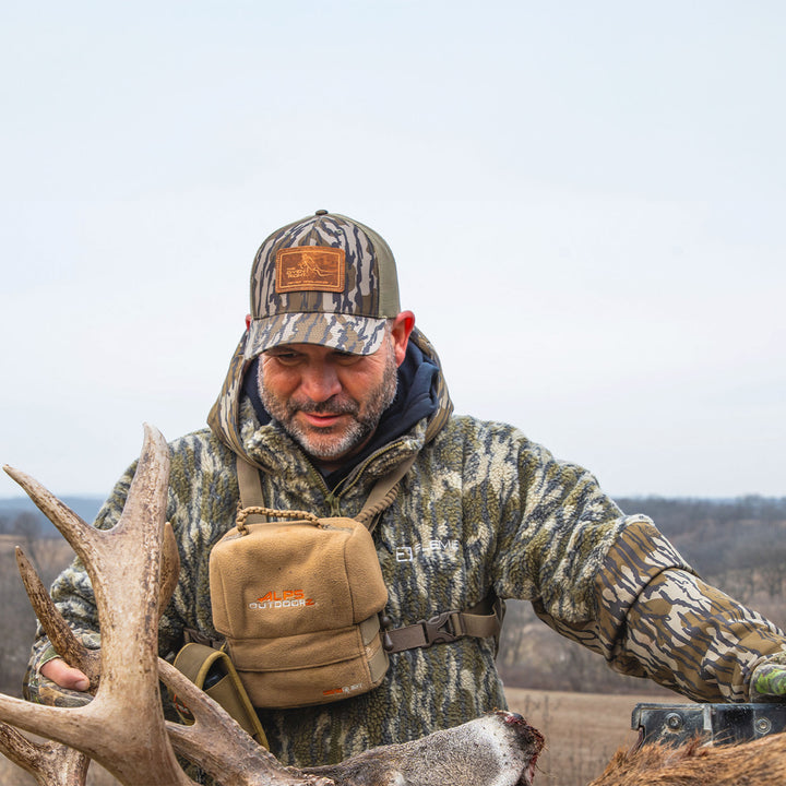 Man standing at the back of a truck wearing Inclement on a cold day#color_original-bottomland