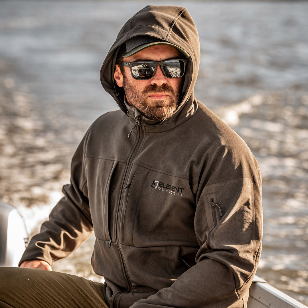 Man in a boat wearing a peak jacket#color_coyote